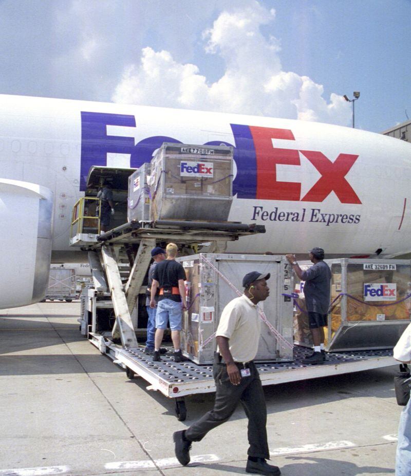 FILE PHOTO: Workers at the FedEx hub in Memphis, Tennessee load the first plane to depart since all aircraft were grounded in the wake of the attacks on the World Trade Center and Pentagon, September 13, 2001. (Photographer: Gene Mangiante/ Bloomberg News)