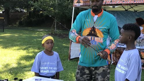 Former NFL player Kendall Newson runs a nonprofit called Teach a Child to Fish. He teaches youth to fish, something he has done since he was five years old. Here he is with participants Rico Hill and Richard Crowder.