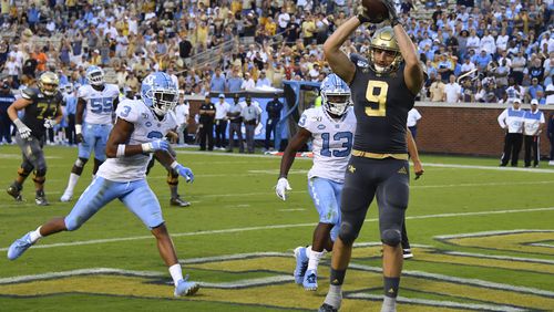 Georgia Tech tight end Tyler Davis (9) scores a touchdown with North Carolina linebacker Dominique Ross (3) and defensive back Don Chapman defending during the second half of an NCAA college football game against North Carolina, Saturday, Oct. 5, 2019, in Atlanta. North Carolina won 38-22. (Special-John Amis)