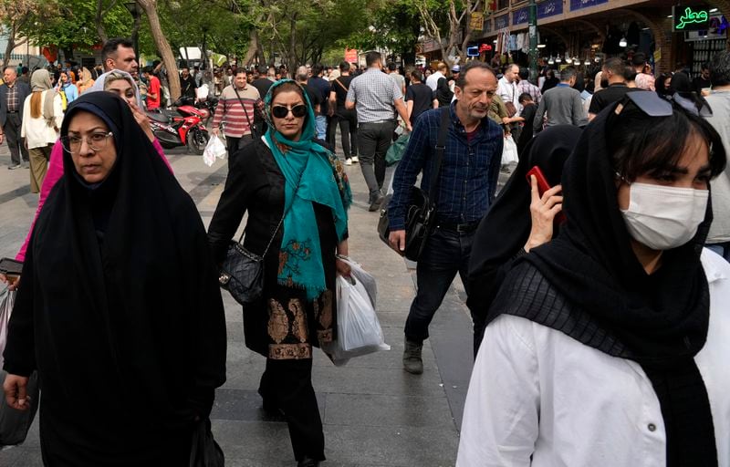 People walk around the old main bazaar in Tehran, Iran, Tuesday, April 16, 2024. Israel says it is poised to retaliate against Iran, risking further expanding the shadow war between the two foes into a direct conflict after an Iranian attack over the weekend sent hundreds of munitions into Israeli airspace. (AP Photo/Vahid Salemi)