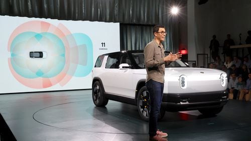 Founder and CEO of Rivian RJ Scaringe speaks onstage during the Rivian Reveals All-Electric R2 Midsize SUV event at Rivian South Coast Theater on March 07, 2024 in Laguna Beach, California. (Photo by Phillip Faraone/Getty Images for Rivian)
