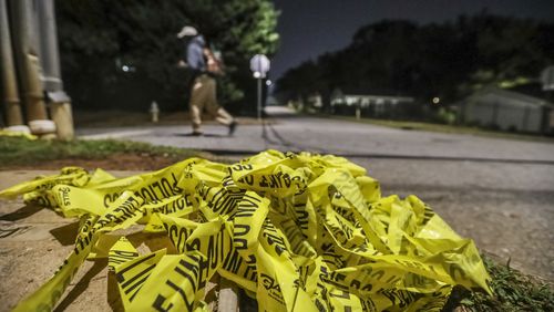 Crime tape lay strewn across the road in the 1000 block of Welch Street SW in this Oct. 6, 2020, file photo. (John Spink / John.Spink@ajc.com)