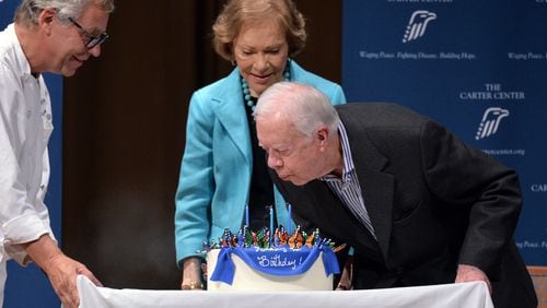 Former President Jimmy Carter blows out the candles on his cake for his 90th birthday celebration with staff and guests at the Day Chapel of the Ivan Allen III Pavilion at the Carter Center on Wednesday, October 1, 2014. HYOSUB SHIN / HSHIN@AJC.COM