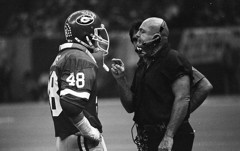 Linebacker Frank Ros speaks with defensive coordinator Erk Russell in 1980. 