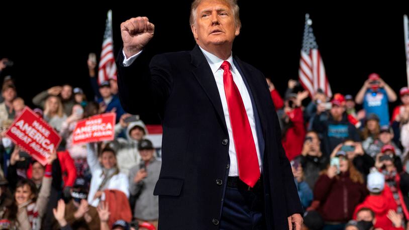 US President Donald Trump holds up his fist as he leaves the stage at the end of a rally to support Republican Senate candidates at Valdosta Regional Airport in Valdosta, Georgia on December 5, 2020.   (ANDREW CABALLERO-REYNOLDS/AFP via Getty Images/TNS)