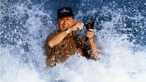 November 1988: President-elect George Bush fishes in a strong surf off the Gulf Stream during his vacation at the home of William Farish immediately following the election. (Allen Eyestone / The Palm Beach Post)