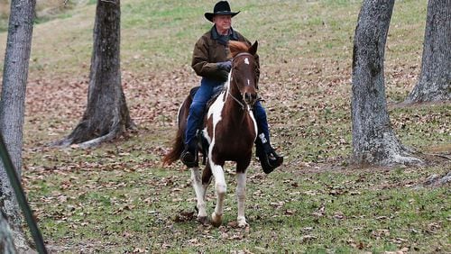 U.S. Senate candidate Roy Moore rides a horse to vote, Dec. 12, 2017, in Gallant, Ala.
