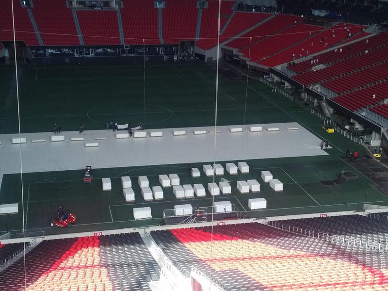  Stage crews started laying the flooring for Kenny Chesney's setup on Monday morning at Mercedes-Benz Stadium. Photo: Melissa Ruggieri/AJC
