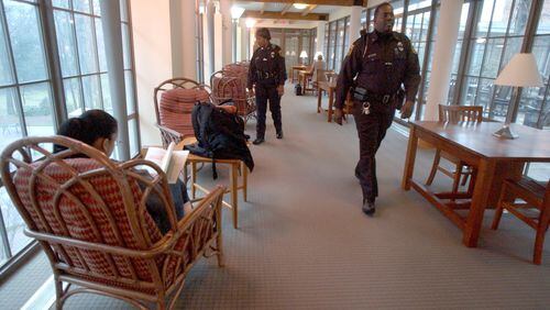 Gioconda Lewis, front, then an officer with Agnes Scott College, patrols the campus in 2005. Lewis was subsequently fired from the college for driving on a suspended license but found jobs in other agencies, including Spelman College. SUNNY SUNG / AJC