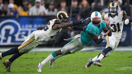 Miami Dolphins wide receiver DeVante Parker catches a pass under pressure by Los Angeles Rams outside linebacker Mark Barron during the second half of an NFL football game Sunday, Nov. 20, 2016, in Los Angeles. (AP Photo/Mark J. Terrill)
