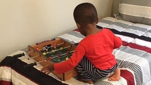 A boy plays on the bed at one of Family Promise’s host congregations. CONTRIBUTED
