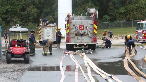 Cherokee County firefighters roll out their hoses at the Fire Training Center in Holly Springs to test them to ensure they meet national standards. CHEROKEE COUNTY FIRE & EMERGENCY SERVICES