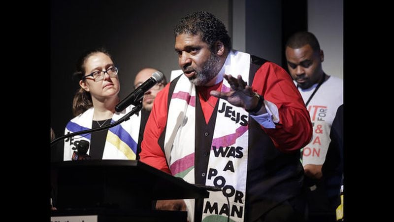  The Rev. Dr. William J. Barber II (second from left) and the Rev. Dr. Liz Theoharis (left), co-chairs of the Poor People's Campaign, speak at the National Civil Rights Museum earlier this year in Memphis, Tenn. (AP Photo/Mark Humphrey) 