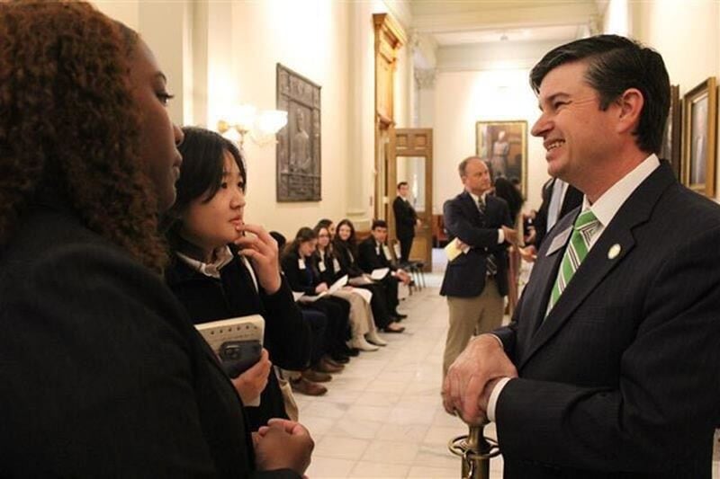 Coweta County teens Cameron Hammett (foreground) and Hannah Lee talk to Sen. Matt Brass, R-Newnan, about proposed voucher legislation at the General Assembly on Thursday, March 2, 2023. The students are part of the Georgia Youth Justice Coalition. (Courtesy of Georgia Youth Justice Coalition)