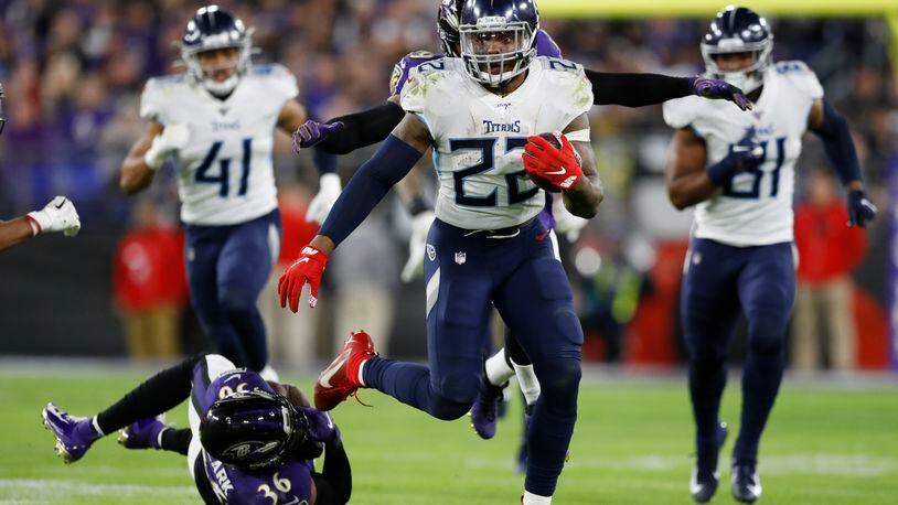 Tennessee Titans running back Derrick Henry (22) runs past Baltimore Ravens strong safety Chuck Clark (36) during the second half of an NFL divisional playoff football game, Saturday, Jan. 11, 2020, in Baltimore. (AP Photo/Julio Cortez)