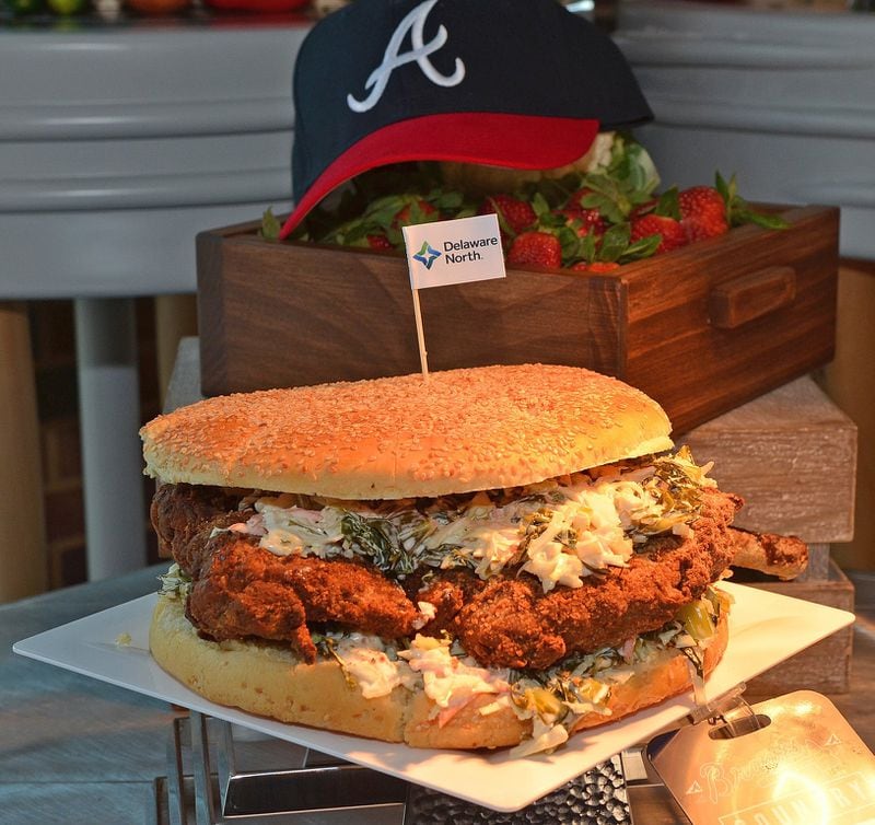 The fried tomahawk pork chop sandwich is sold at the Braves Big Bites stand in Section C113. (CHRIS HUNT /SPECIAL TO THE AJC)