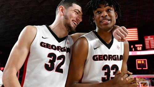 Mike Edwards (32) and Nicolas Claxton of the Georgia Bulldogs embrace as they walk off the floor following the Bulldogs' win over the Tennessee Volunteers at Stegeman Coliseum on February 17, 2018 in Athens, Georgia. (Photo by Mike Comer/Getty Images)