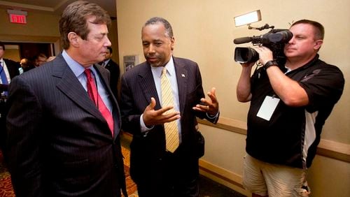 Donald Trump strategist Paul J. Manafort, left, chats with former presidential candidate Ben Carson as they head to a Trump for president reception at the Republican National Committee Spring Meeting, Thursday, April 21, 2016, in Hollywood, Fla. (AP Photo/Wilfredo Lee)
