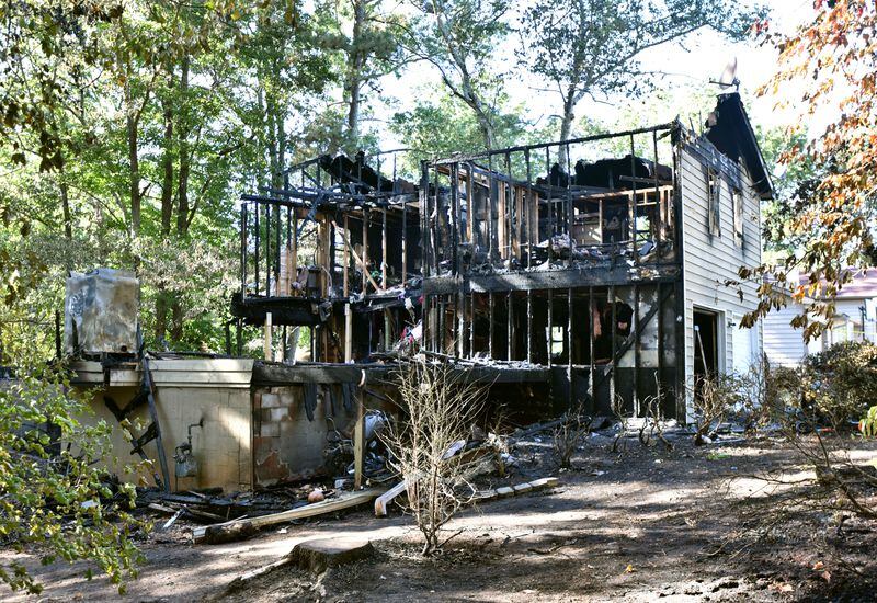 Five adults were found dead after a fire gutted a home in the 2200 block of Post Oak Drive in unincorporated Duluth early Sunday morning. HYOSUB SHIN / HSHIN@AJC.COM