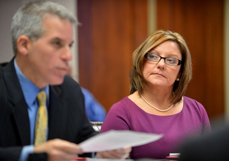 Cherokee school board member Kelly Marlow listens to her defense attorney Brian Steel present her case during a hearing Thursday, November 14, 2013, before a panel appointed by the governor to convince them not to remove her from office while her criminal proceedings move forward.