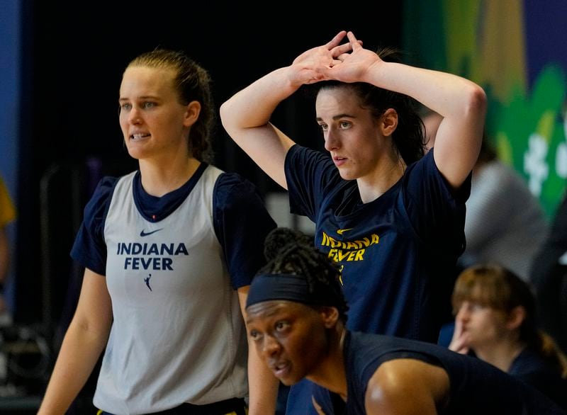 Indiana Fever guard Caitlin Clark, top right, watches from the sideline as the WNBA basketball team practices in Indianapolis, Sunday, April 28, 2024. (AP Photo/Michael Conroy)