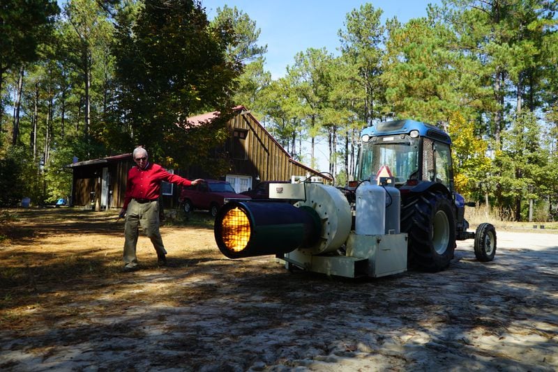 Don Starrett of BluStarr Farms demonstrates how his "frost dragon," a piece of equipment used to keep blueberries from freezing, works on his farm near Dearing, Georgia on October 24, 2022.
