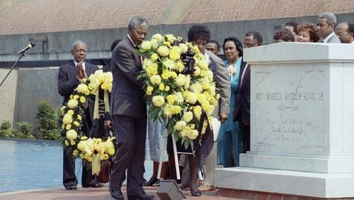 Nelson Mandela, deputy president of the African National Congress, and his wife Winnie place a wreath at the tomb of the Rev. Martin Luther King Jr. in Atlanta.