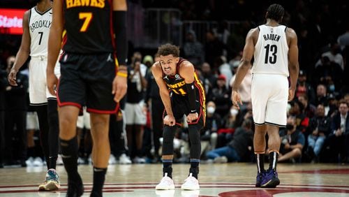 The Hawks' Trae Young (11) grimaces during a game between the Atlanta Hawks and the Brooklyn Nets at State Farm Arena in Atlanta, GA., on Friday, December 10, 2021. The Nets won 113-105. (Photo/ Jenn Finch)