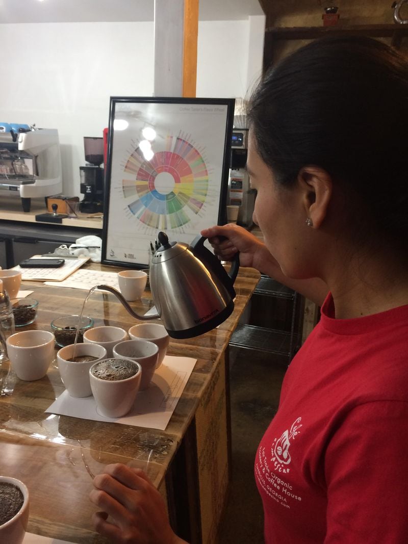  Esme Hernandez of Cafe Campesino prepares the company's training lab for a coffee cupping./ Nema Etheridge