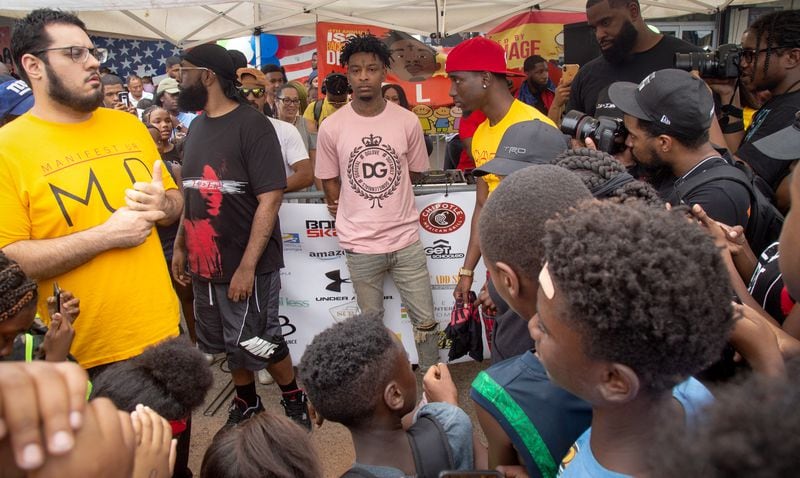 People surround 21 Savage as he walks into the fourth annual "Issa Back 2 School Drive" on Sunday, August 4, 2019 in Decatur. STEVE SCHAEFER / SPECIAL TO THE AJC