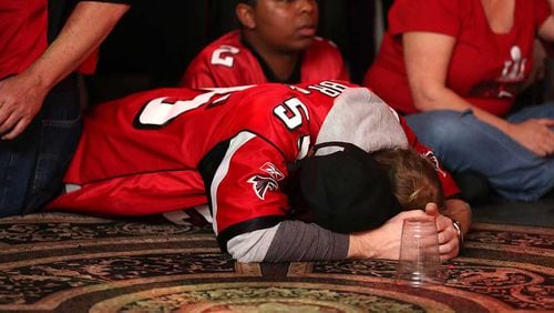 A Falcons fan reacts at the Park Tavern in Atlanta after the Falcons lost to the Patriots 34-28 in Super Bowl LI in Houston.