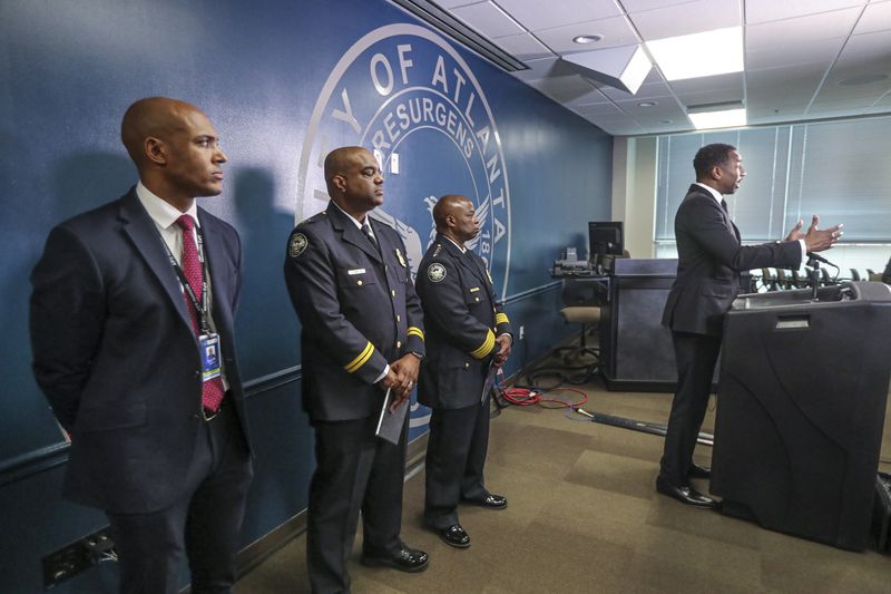 Atlanta Mayor Andre Dickens speaks at a press conference at APD headquarters as police command staff look on. (John Spink / John.Spink@ajc.com)

