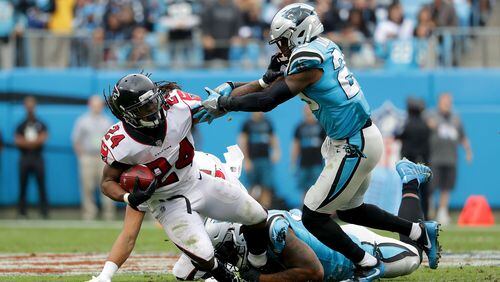 Devonta Freeman (24) of the Atlanta Falcons runs the ball against Mike Adams (29) of the Carolina Panthers in the fourth quarter during their game at Bank of America Stadium on November 5, 2017 in Charlotte, North Carolina.  (Photo by Streeter Lecka/Getty Images)