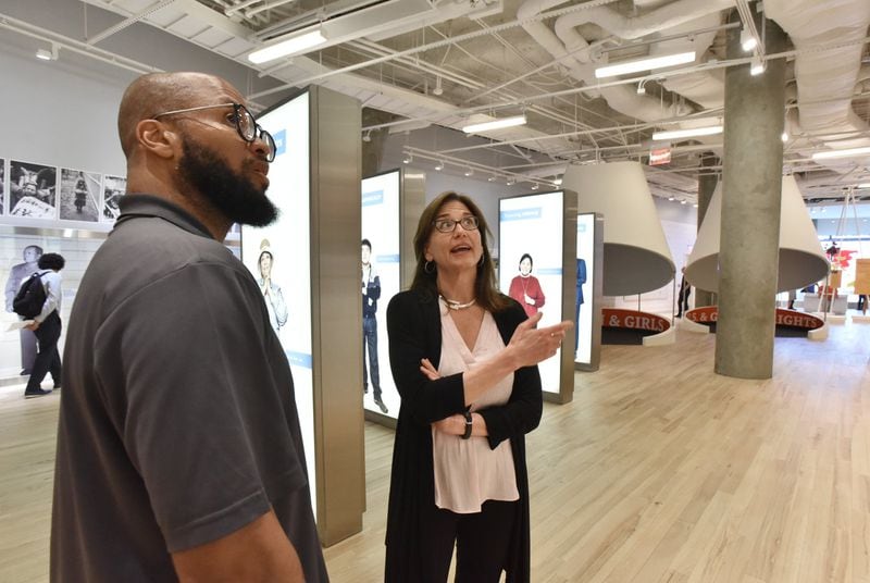 Jill Savitt, the new director of Atlanta’s National Center for Civil and Human Rights, talks to Marcus Lamar, manager of technologies, as they tour “Spark of Conviction,” the human rights exhibit at the center. HYOSUB SHIN/HSHIN@AJC.COM