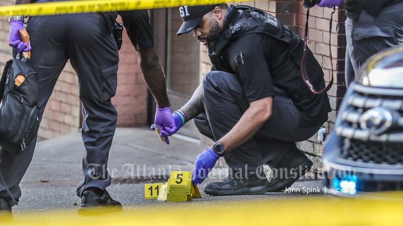 Atlanta police collect evidence from the scene of a double shooting that left one man dead in southeast Atlanta.