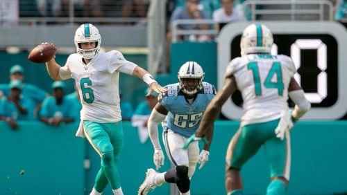 Miami Dolphins quarterback Jay Cutler (6) throws on the run to Miami Dolphins wide receiver Jarvis Landry (14) as he is chased out of the pocket by Tennessee Titans linebacker Jayon Brown (55) at Hard Rock Stadium in Miami Gardens, Florida on October 8, 2017. (Allen Eyestone / The Palm Beach Post)