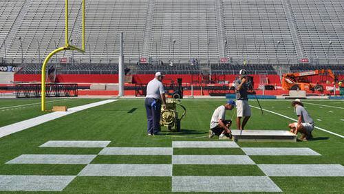 The University of Tennessee's signature end zone checkerboard pattern begins to take shape Monday morning, Sept. 5, 2016, at Bristol Motor Speedway in Bristol, Tenn., as preparations for the Battle at Bristol NCAA college football game between Virginia Tech and Tennessee continue. (Andre Teague/Bristol Herald Courier via AP)
