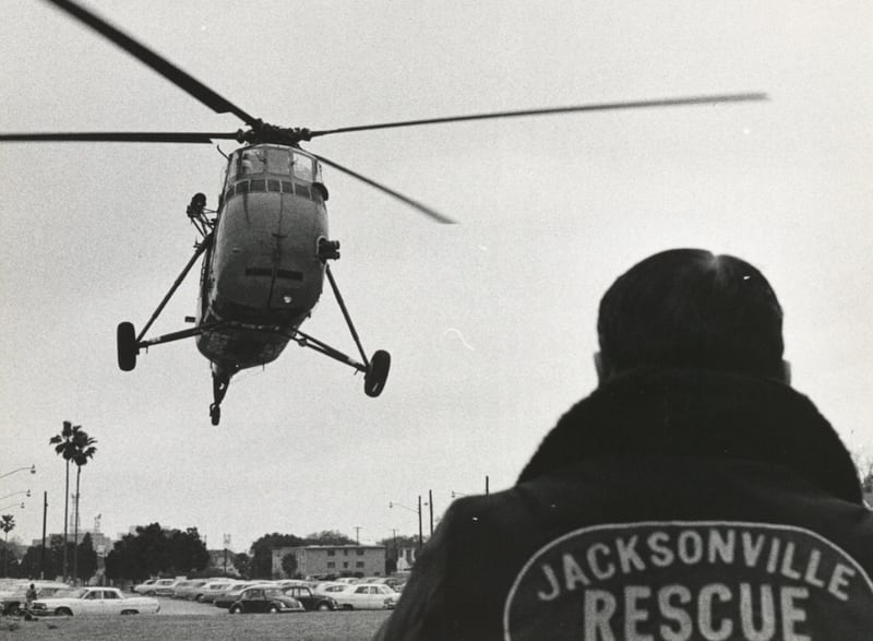 A Jacksonville Rescue officer waits for a US Navy helicopter to land so they can transport patients from the explosion at the Thiokol Chemical plant to the hospital on Feb. 3, 1971.
