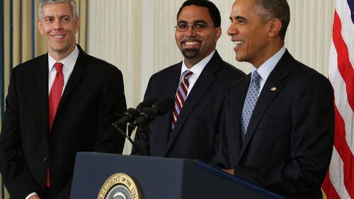 Former President Barack Obama flanked by Deputy Education Secretary John B. King Jr. (C) and Education Secretary Arne Duncan (L) at the White House in 2015. King succeeded Duncan as ed secretary for the final year of the Obama White House. (Photo by Chip Somodevilla/Getty Images)