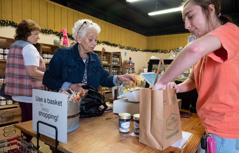 Fran Perkins, center, of Conyers, shops at the Dickey Farms store in Musella on Tuesday, Mar. 28, 2023. Ben Gray for the Atlanta Journal-Constitution