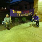 Barry and Carol Walton sat outside Kedron Elementary School in Peachtree City one morning in November 2020 with this handmade sign to thank teachers for their work. The couple were grandparents to students at the school. (Courtesy photo)