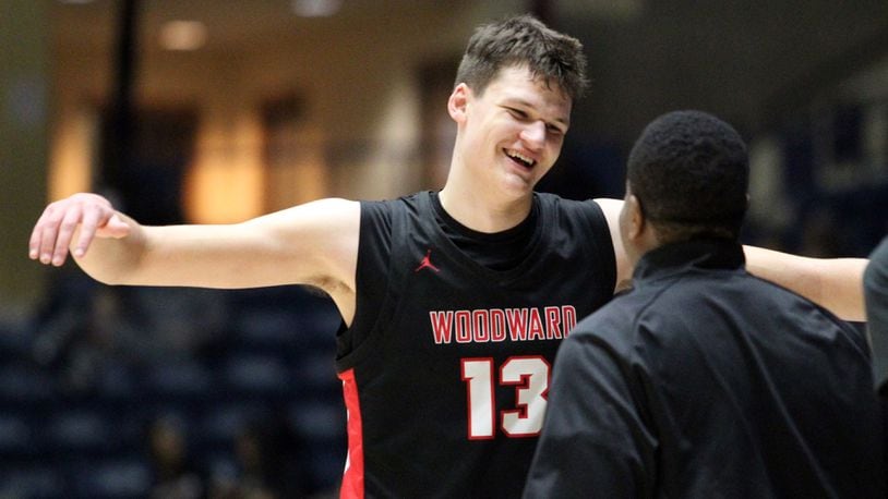 Woodward Academy Walker Kessler (13) celebrates with his coach after their win over Cross Creek of the Class AAAA boys title game Friday, March 6, 2020, at the Macon Centreplex, in Macon.