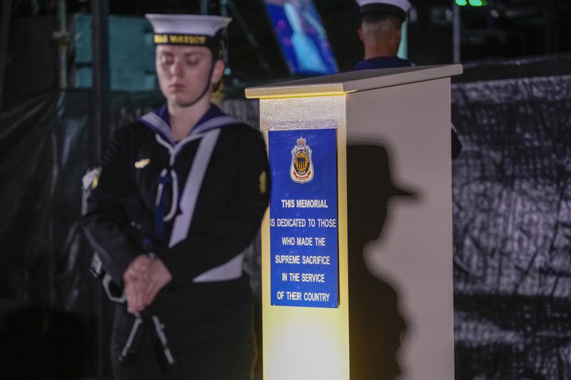 Australian naval personnel stand near a cenotaph during an Anzac Day dawn service at Coogee Beach in Sydney, Australia, Thursday, April 25, 2024. (AP Photo/Mark Baker)