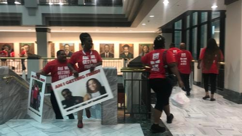 Members of the UNITE HERE union delivered to Atlanta Mayor Kasim Reed's office petition signatures asking for worker retention language in airport concessions contracts.