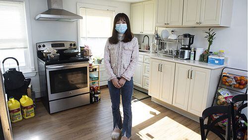 Meidan "Abby" Lin in the kitchen of her apartment in Boston's Chinatown neighborhood. A land trust helped her family buy the unit at a price far below market value.