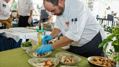 Chef Andrew Smith of West Egg prepares shrimp and grits at the Jekyll Island Shrimp and Grits Festival in 2016.