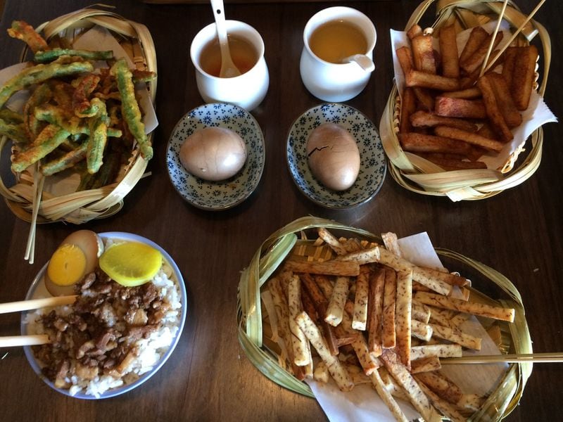 A selection of snacks at Tea House Formosa includes (clockwise from upper left) batter-fried green beans, tea eggs, fried fish cake, taro fries and Lu Rou Fan (ground pork gravy on rice with egg). CONTRIBUTED BY WENDELL BROCK