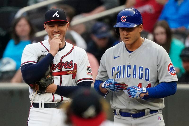 Atlanta Braves first baseman Freddie Freeman (5) laughs as he talks to Chicago Cubs first baseman Anthony Rizzo (44) during the second inning of a baseball game Thursday, April 29, 2021, in Atlanta. Rizzo was used as a relief pitcher the night before and struck Freeman out. (AP Photo/John Bazemore)