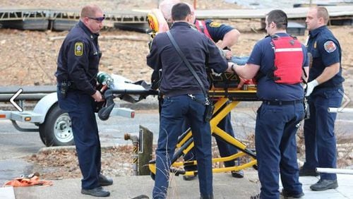 Crews remove an injured man from the scene of a deadly two-boat collision Thursday on Lake Allatoona. (Credit: Cherokee Fire and Emergency Services)