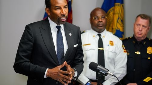 The owner of Manuel’s Tavern said the midtown Atlanta bar was vandalized early Wednesday ahead of a speech that Mayor Andre Dickens (left) delivered to Democratic supporters. (Ben Hendren for the Atlanta Journal-Constitution)